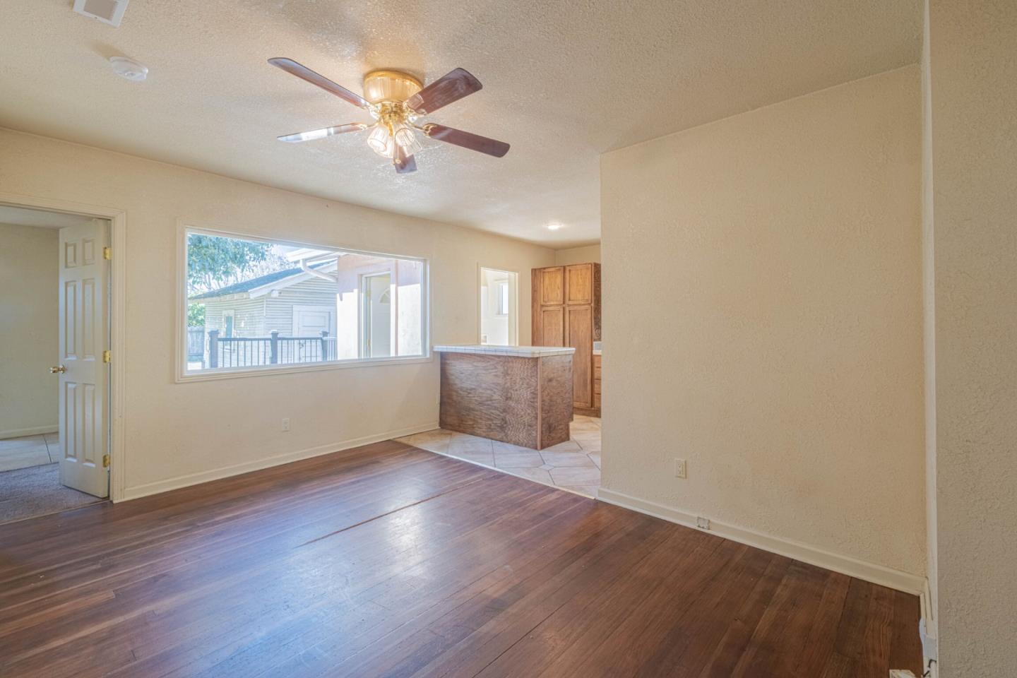 40 Oak Street Salinas, CA 93901 - Photo 8 of 28 an empty room with wooden floor chandelier fan and windows