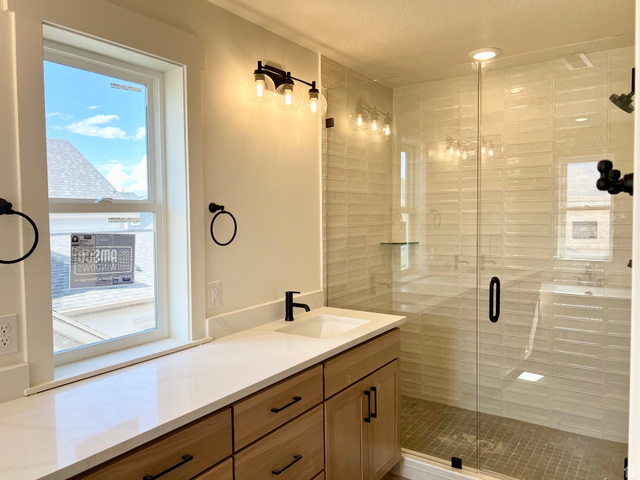 11507 Markfield Way, Unit 1124 South Jordan, UT 84009 - Photo 6 of 6 Bathroom featuring a light wood-finish vanity with a white solid surface countertop, an undermount sink, and a matte black single-handle faucet
