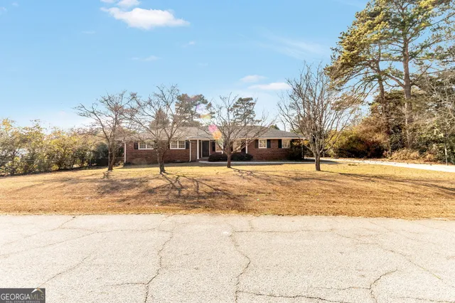 a view of houses with snow on the road