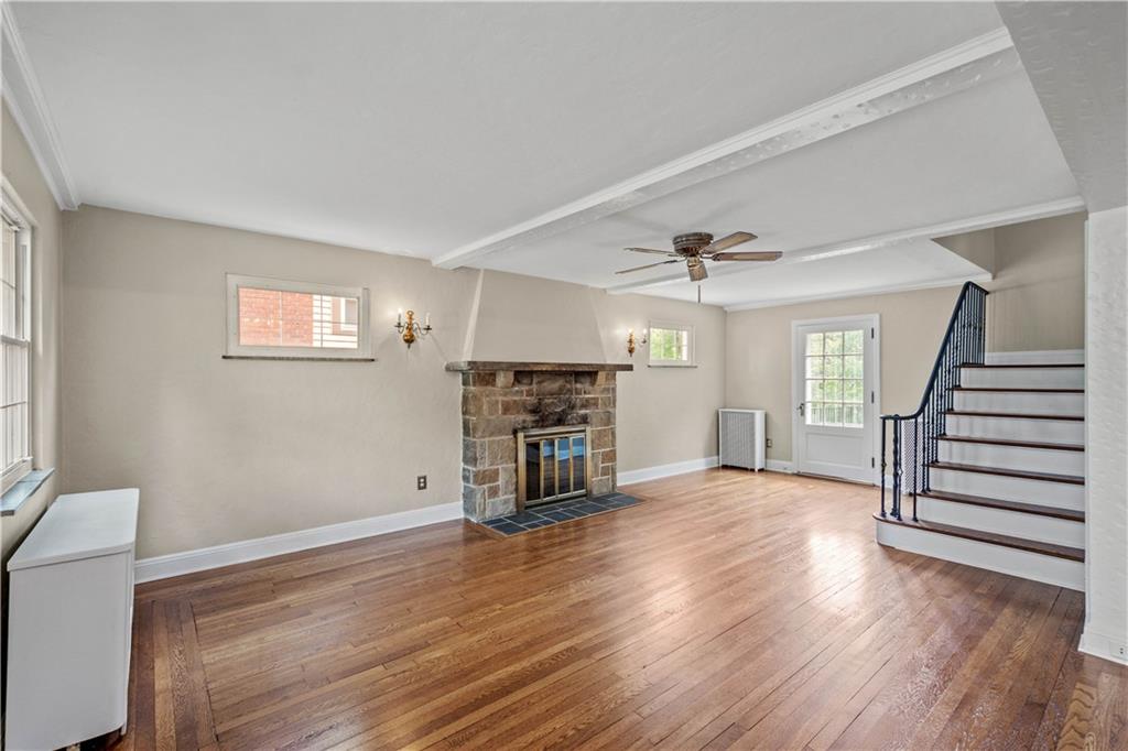 220 Cochran Road Mt. Lebanon, PA 15228 - Photo 14 of 35 an empty room with wooden floor fireplace and windows