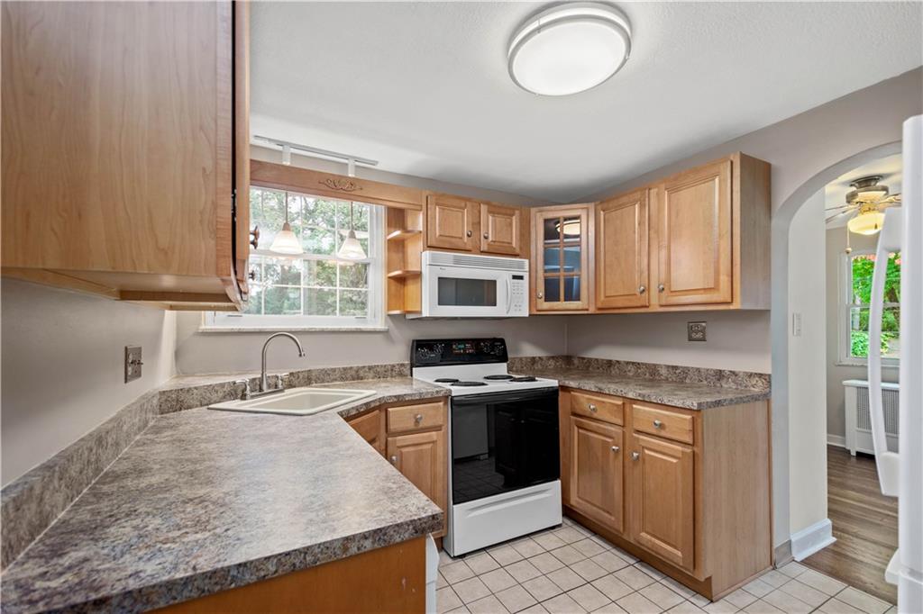 220 Cochran Road Mt. Lebanon, PA 15228 - Photo 17 of 35 a kitchen with stainless steel appliances granite countertop a stove a sink and a microwave