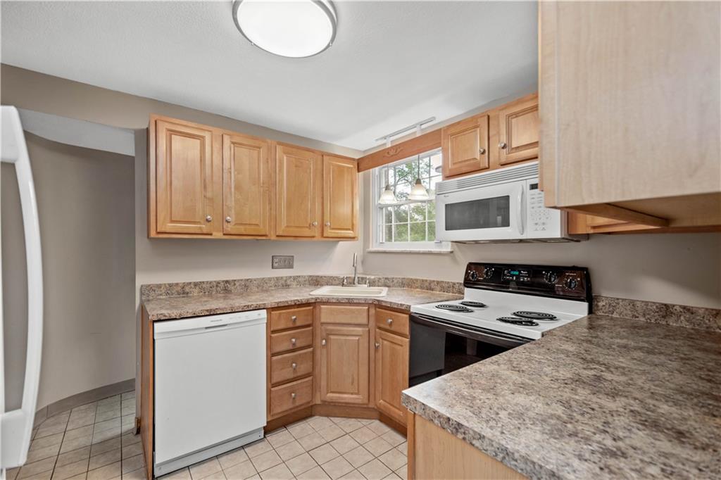 220 Cochran Road Mt. Lebanon, PA 15228 - Photo 18 of 35 a kitchen with a stove sink and cabinets