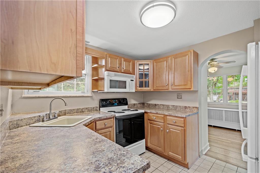 220 Cochran Road Mt. Lebanon, PA 15228 - Photo 20 of 35 a kitchen with stainless steel appliances granite countertop a sink stove and cabinets
