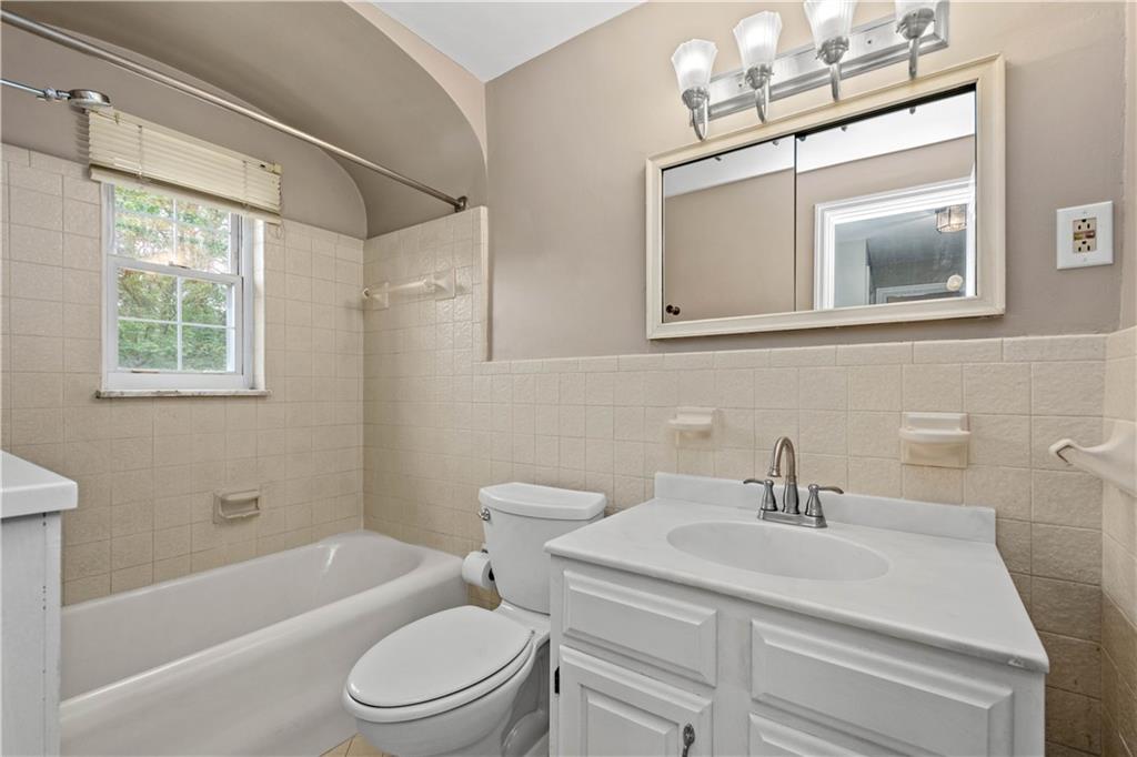 220 Cochran Road Mt. Lebanon, PA 15228 - Photo 23 of 35 a bathroom with a sink toilet a mirror and shower