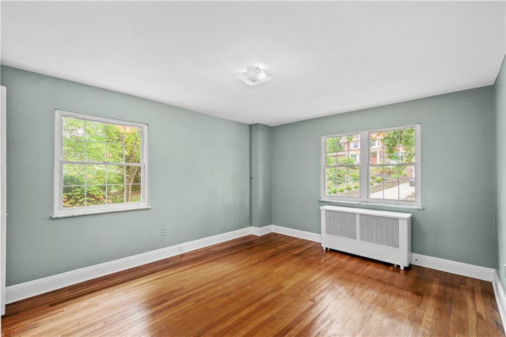 220 Cochran Road Mt. Lebanon, PA 15228 - Photo 24 of 35 a view of an empty room with wooden floor and a window