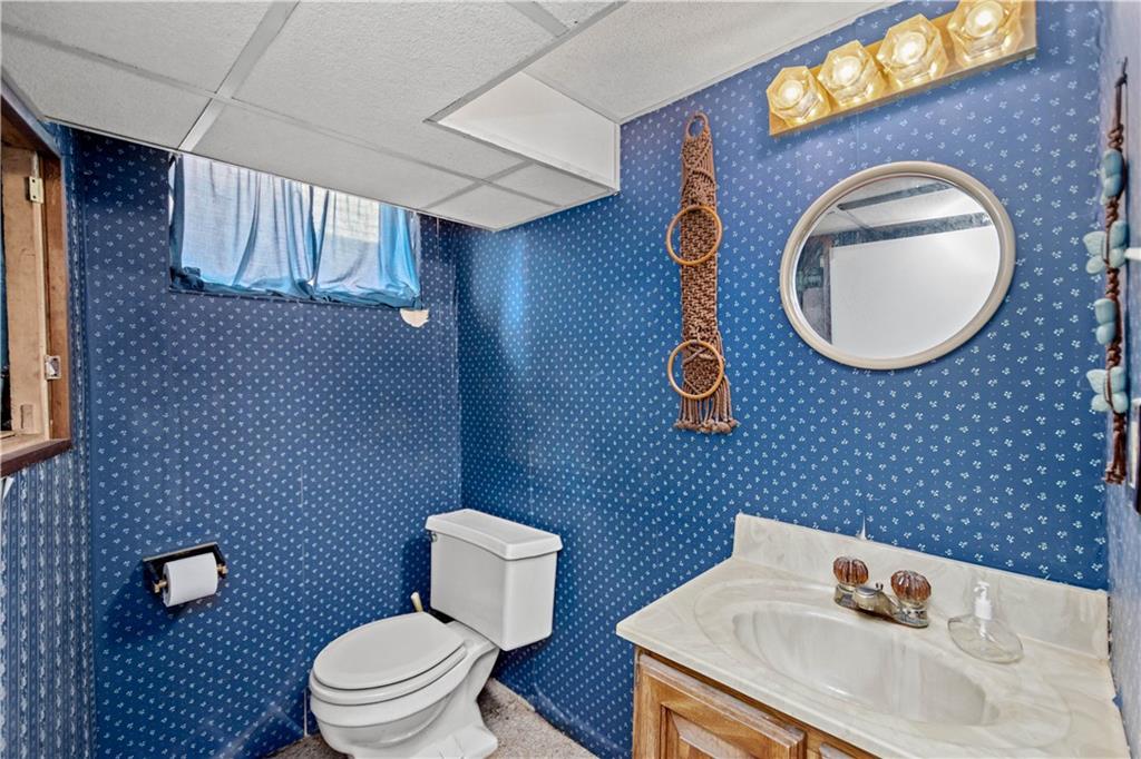 220 Cochran Road Mt. Lebanon, PA 15228 - Photo 34 of 35 a bathroom with a toilet a sink and mirror