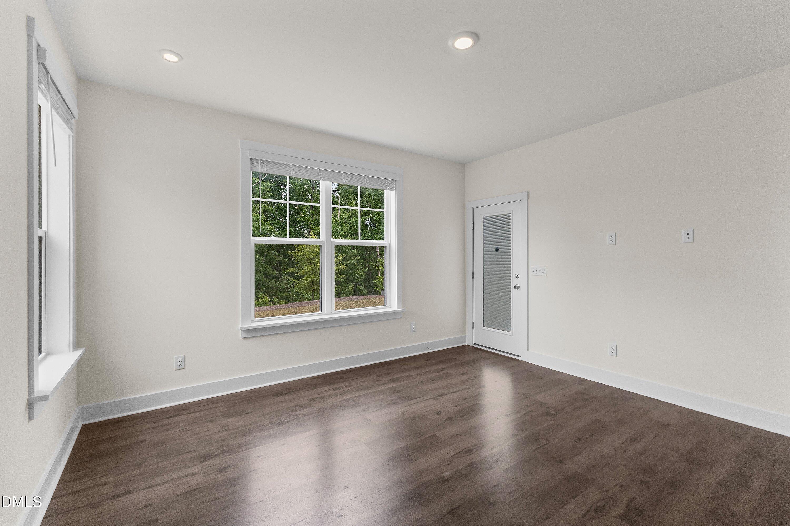 156 Sears Ridge Lane Morrisville, NC 27560 - Photo 12 of 49 an empty room with wooden floor and windows
