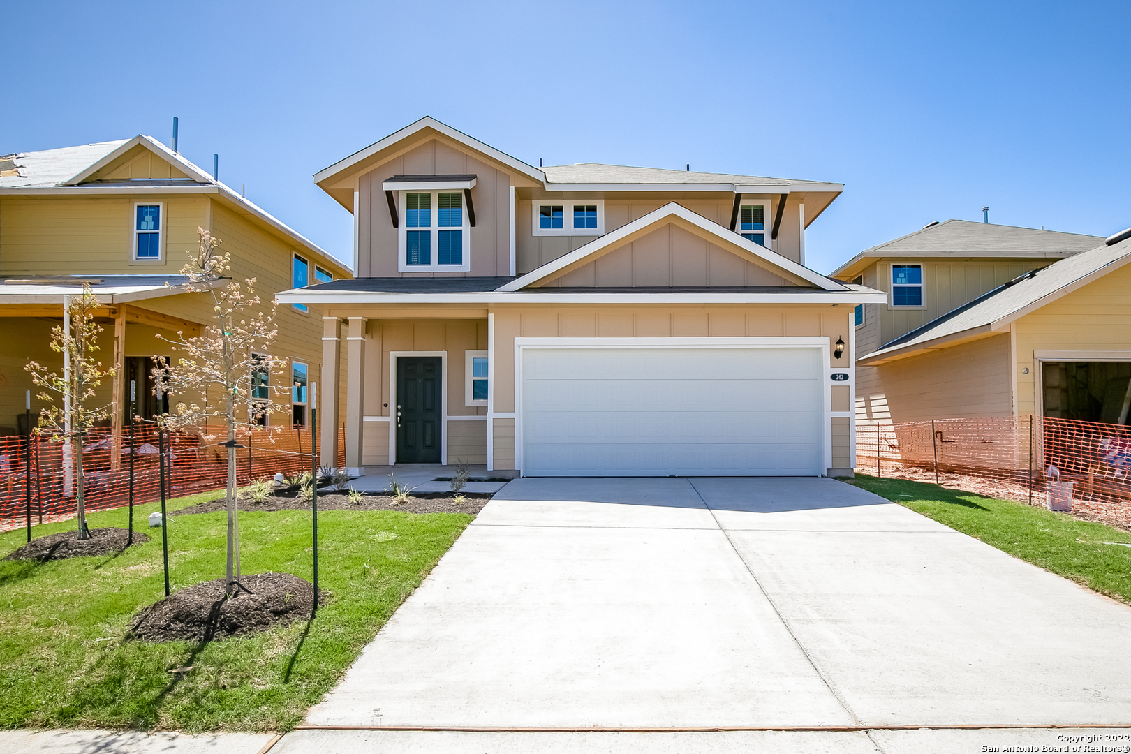 a front view of a house with a yard and porch