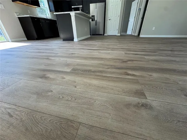 a view of a room with wooden floor