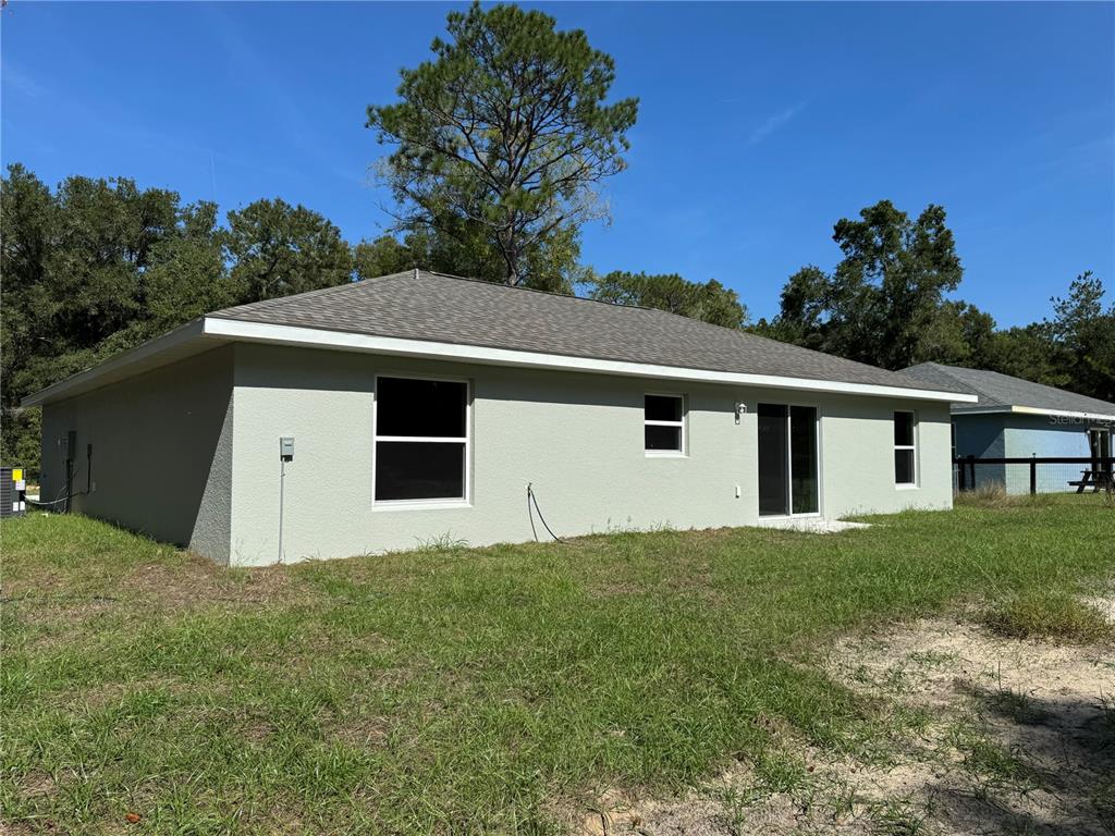 14876 Southwest 23rd Place Ocala, FL 34481 - Photo 23 of 26 a front view of a house with a yard