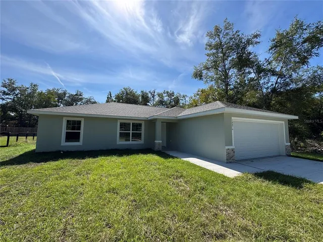 a backyard of a house with yard and garage