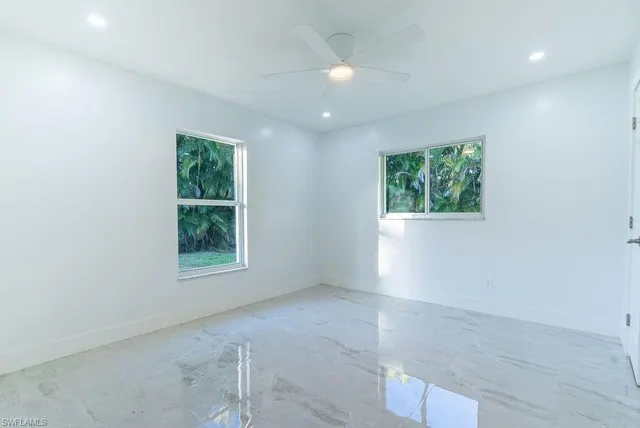 an empty room with windows and closet