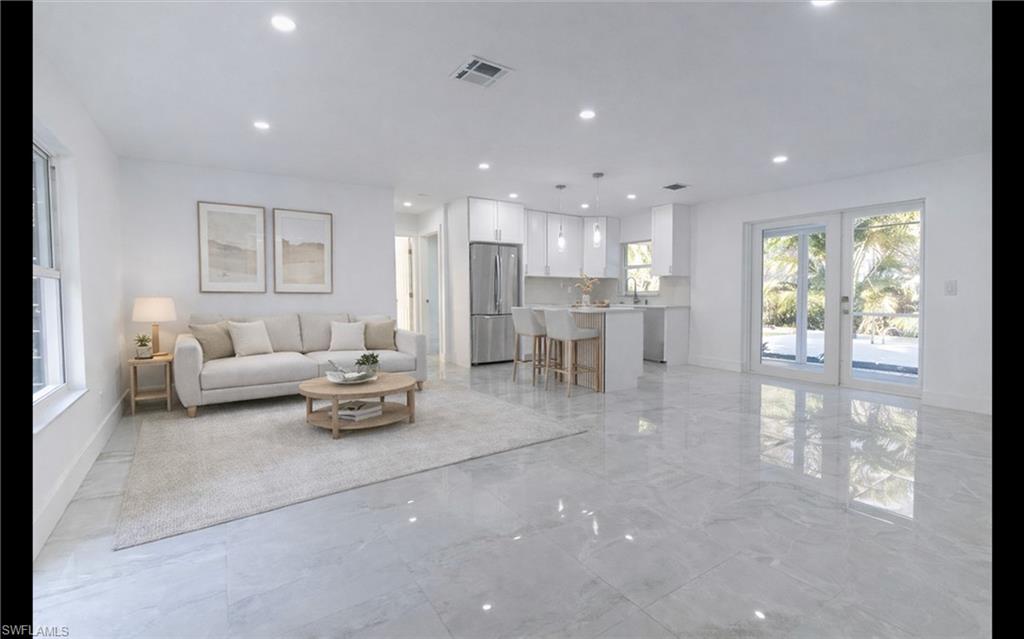 5431 23rd Avenue Southwest Naples, FL 34116 - Photo 22 of 40 a living room with furniture and a table