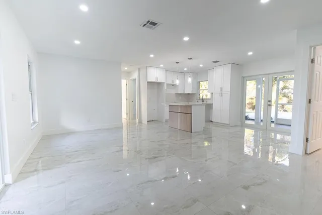 a view of a kitchen with refrigerator and a counter top space
