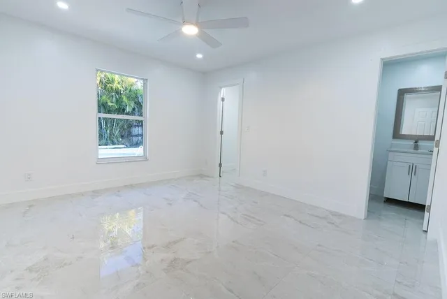 an empty room with windows and closet