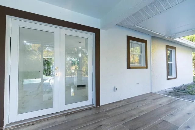 en empty room with window and wooden floor
