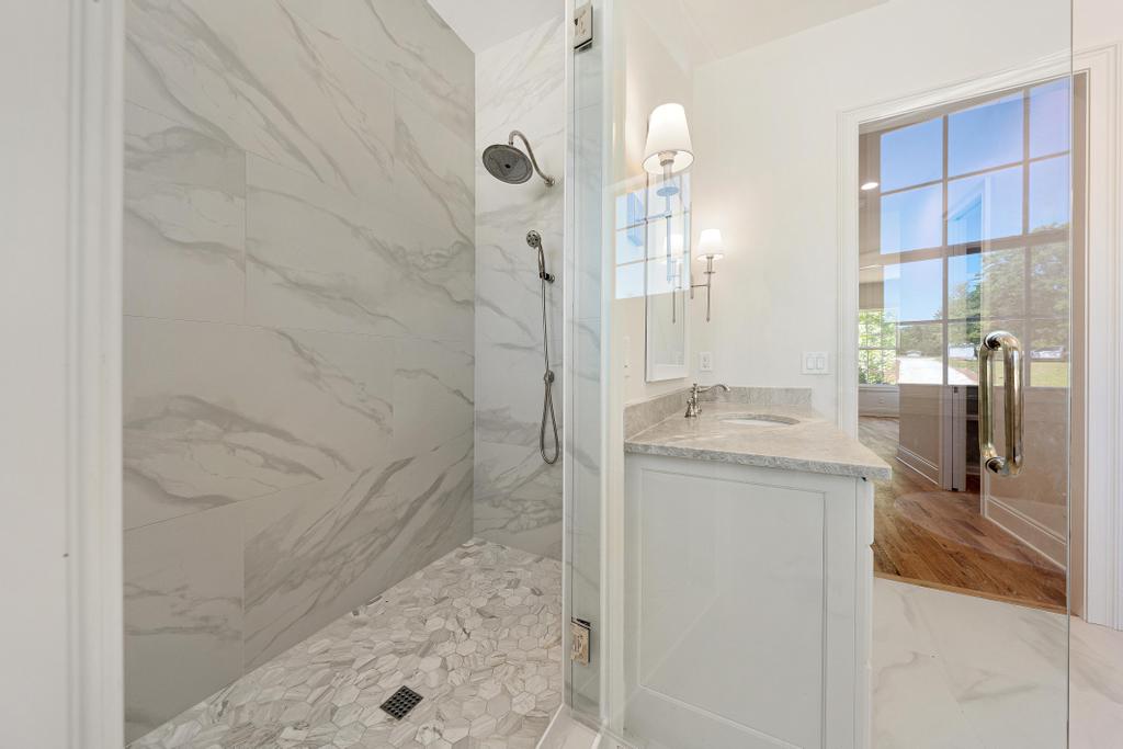 707 Vickery Street Extension Hartwell, GA 30643 - Photo 22 of 50 A well-appointed bathroom with a spacious walk-in shower and elegant vanity.