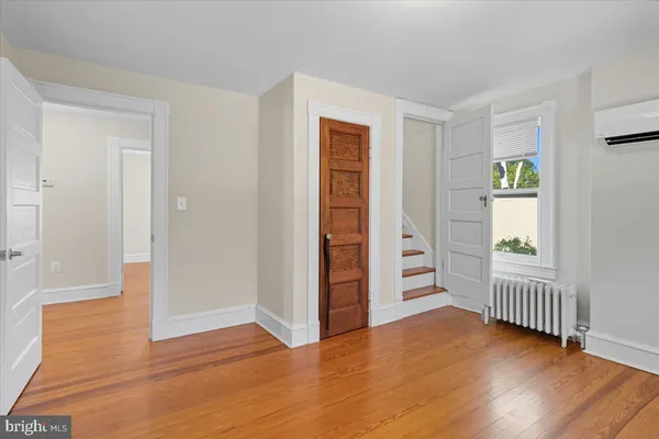 a view of empty room with wooden floor