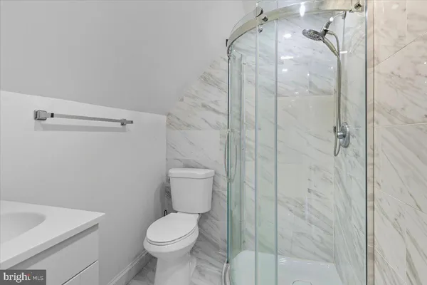 a bathroom with a shower toilet and sink