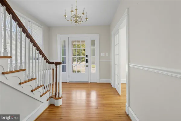 a view of an entryway with wooden floor and stairs
