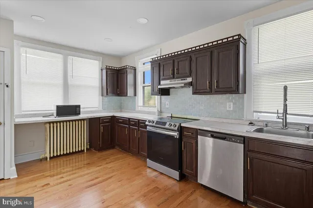 a kitchen with a sink stove and cabinets