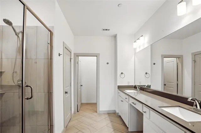 a spacious bathroom with a granite countertop sink mirror and double