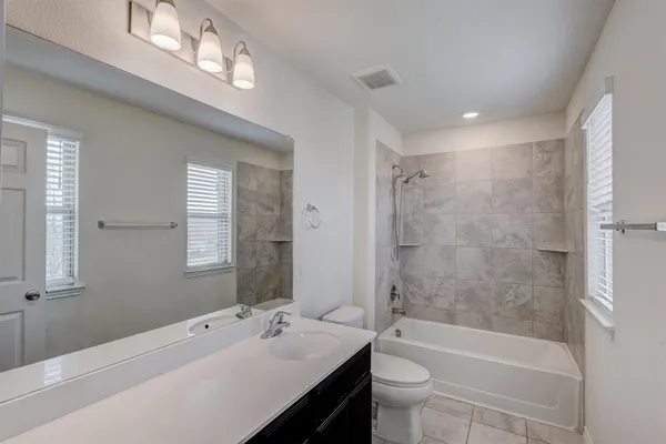 a bathroom with a double vanity sink and mirror