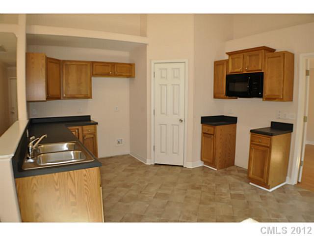 3968 Kiser Island Road, Unit 2 Terrell, NC 28682 - Photo 10 of 16 a living room with a fireplace furniture and a flat screen tv