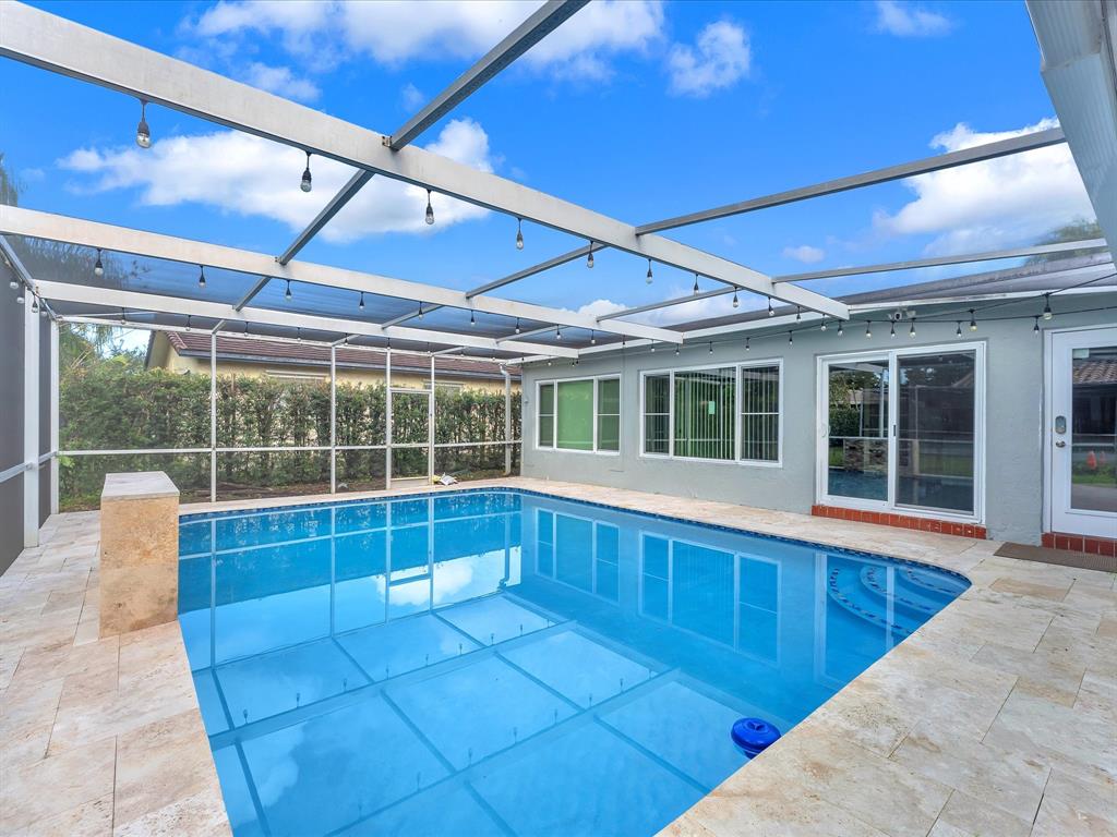 11762 Northwest 26th Court Coral Springs, FL 33065 - Photo 1 of 37 a view of a patio with a table and chairs