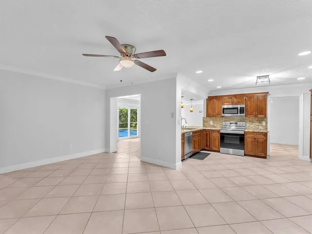 a view of an empty room with a kitchen