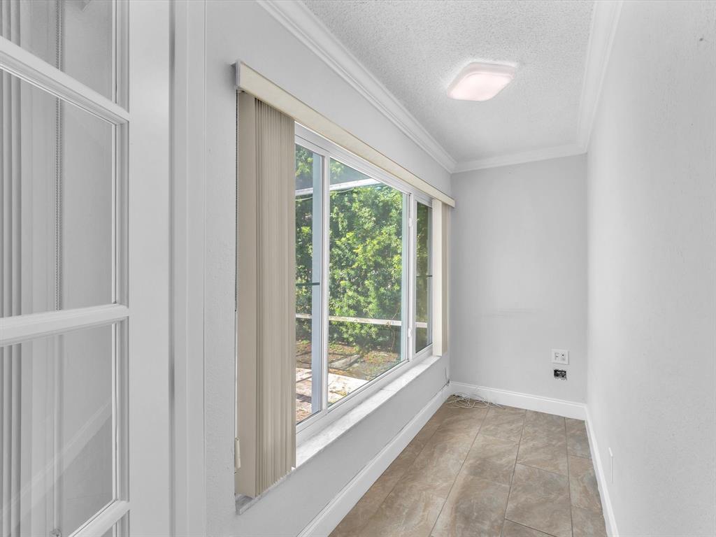 11762 Northwest 26th Court Coral Springs, FL 33065 - Photo 21 of 37 a view of room with a large window and front door