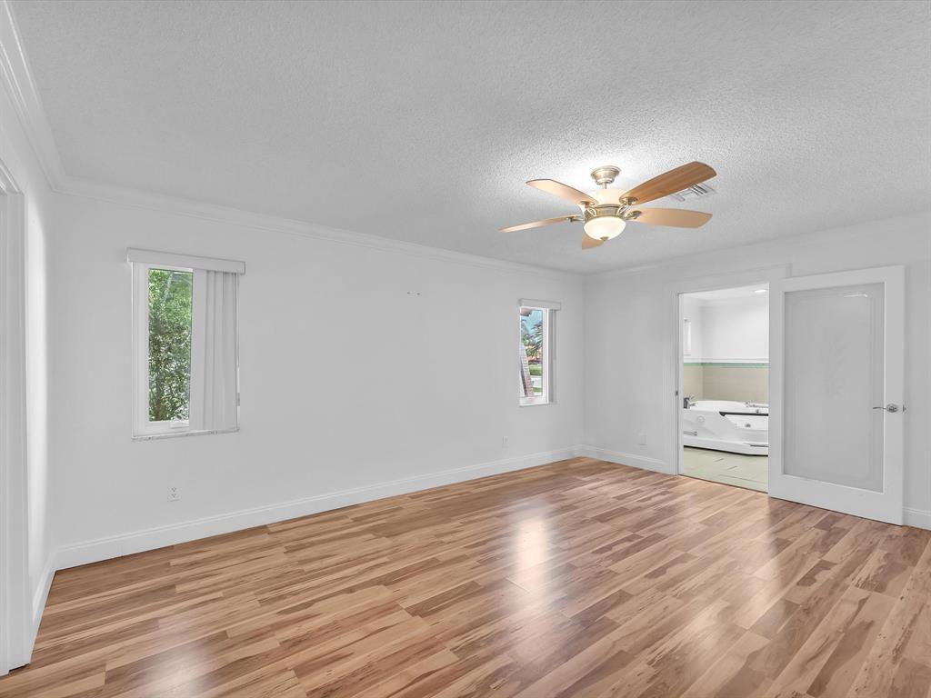 11762 Northwest 26th Court Coral Springs, FL 33065 - Photo 22 of 37 a view of empty room with wooden floor and fan