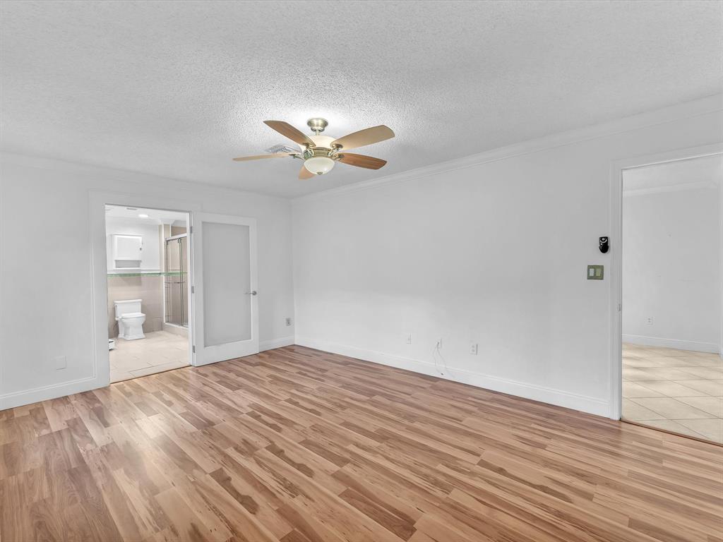 11762 Northwest 26th Court Coral Springs, FL 33065 - Photo 23 of 37 an empty room with wooden floor and windows