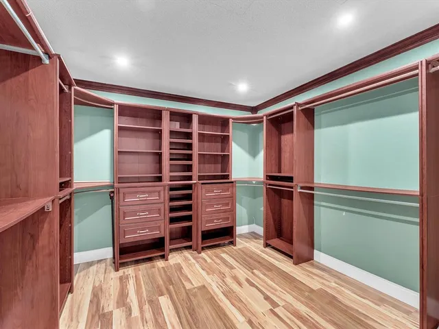 a view of walk in closet with empty racks