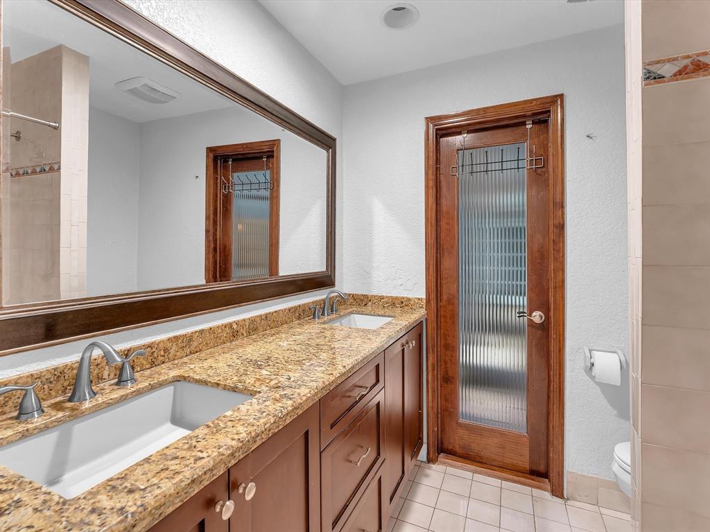 11762 Northwest 26th Court Coral Springs, FL 33065 - Photo 28 of 37 a bathroom with a granite countertop sink and a mirror