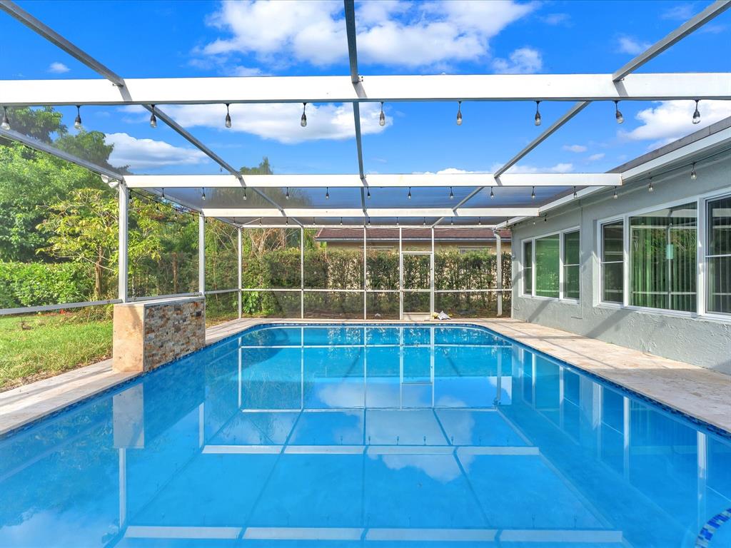 11762 Northwest 26th Court Coral Springs, FL 33065 - Photo 34 of 37 a view of a living room with a floor to ceiling window and wooden floor