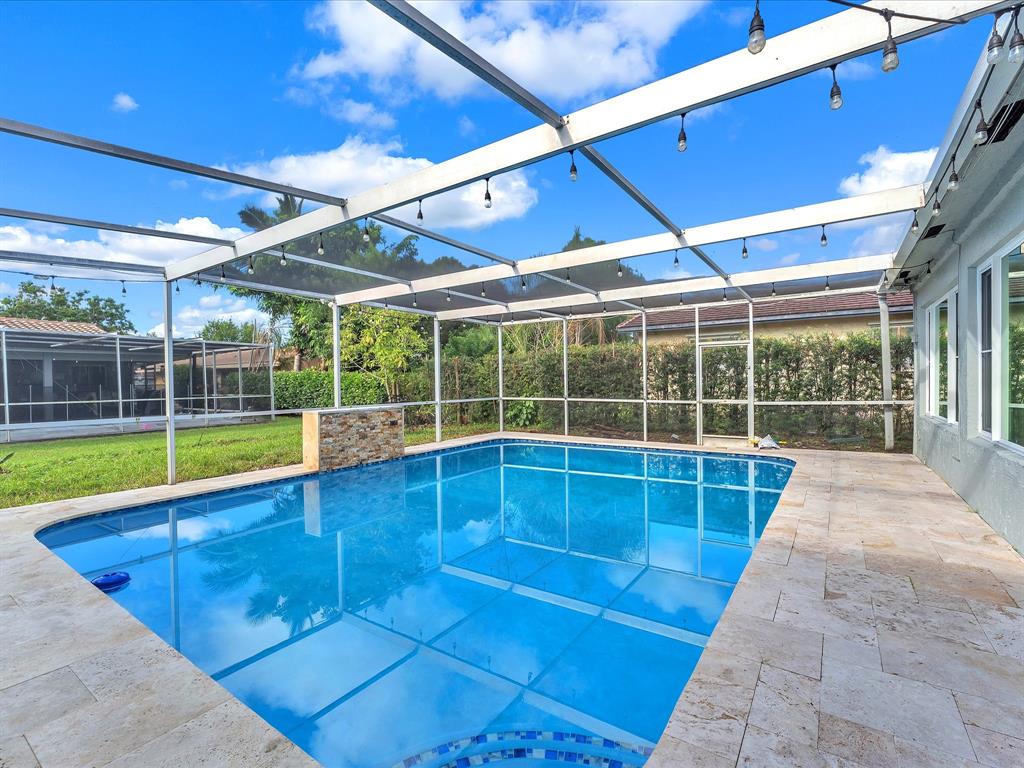 11762 Northwest 26th Court Coral Springs, FL 33065 - Photo 35 of 37 a view of a swimming pool with a porch