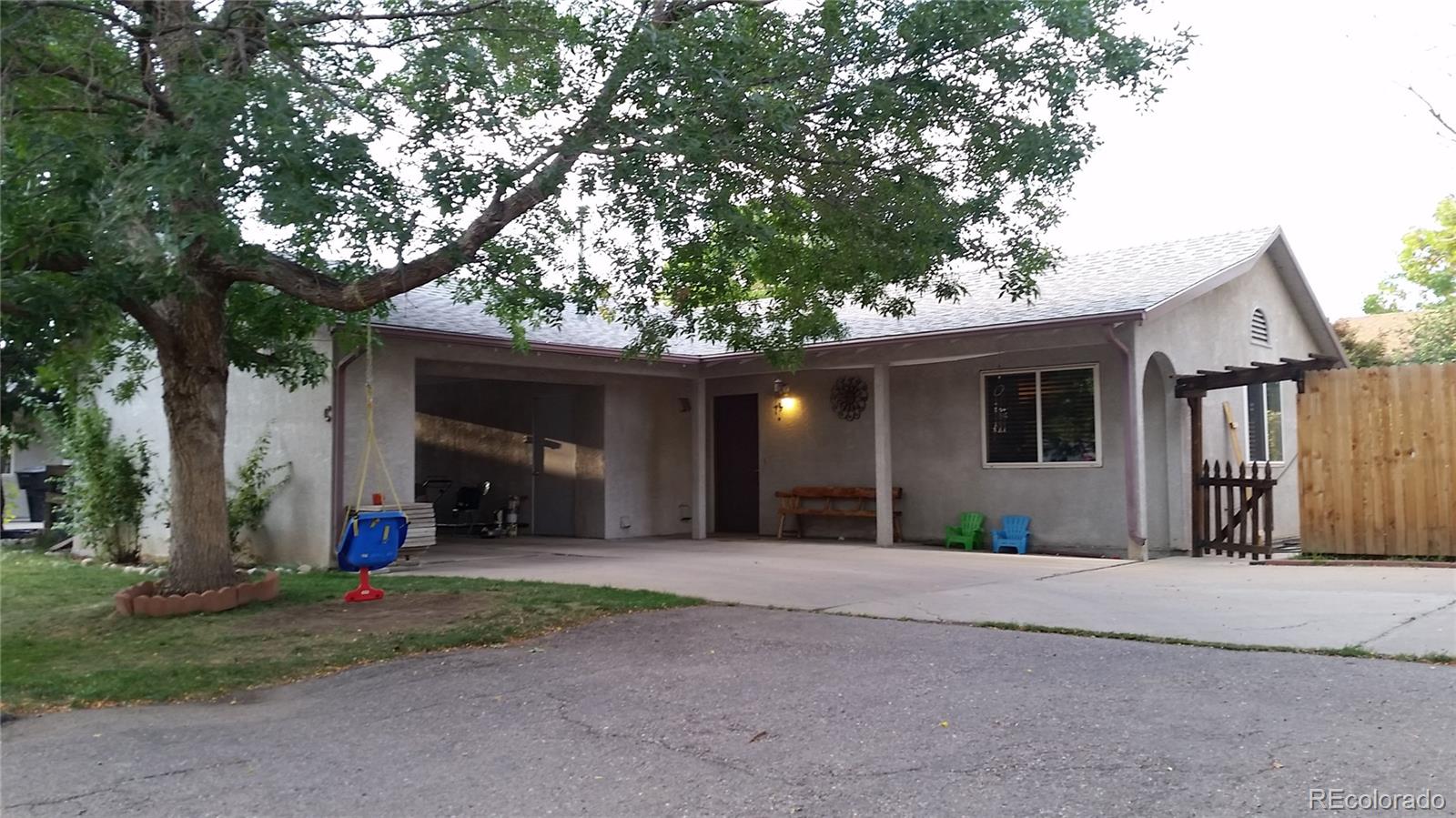 1910 South Decatur Street, Unit C Denver, CO 80219 - Photo 1 of 15 a front view of a house with a yard and garage