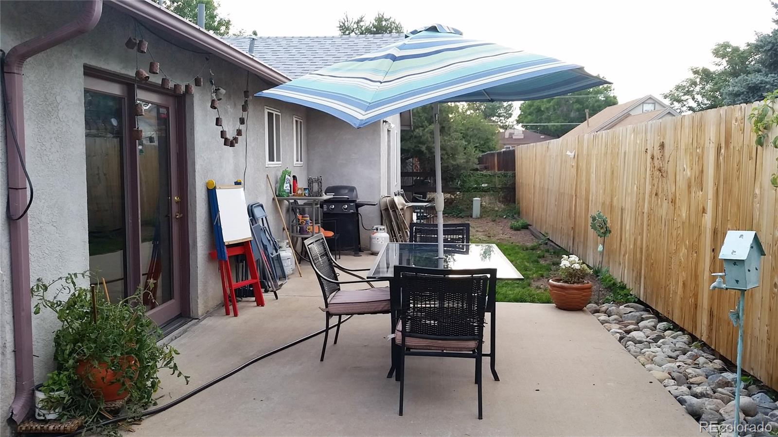 1910 South Decatur Street, Unit C Denver, CO 80219 - Photo 13 of 15 a view of a patio with table and chairs and potted plants