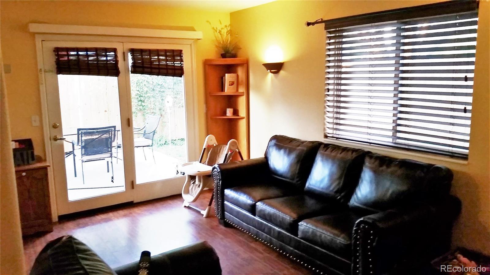 1910 South Decatur Street, Unit C Denver, CO 80219 - Photo 5 of 15 a living room with furniture and a window