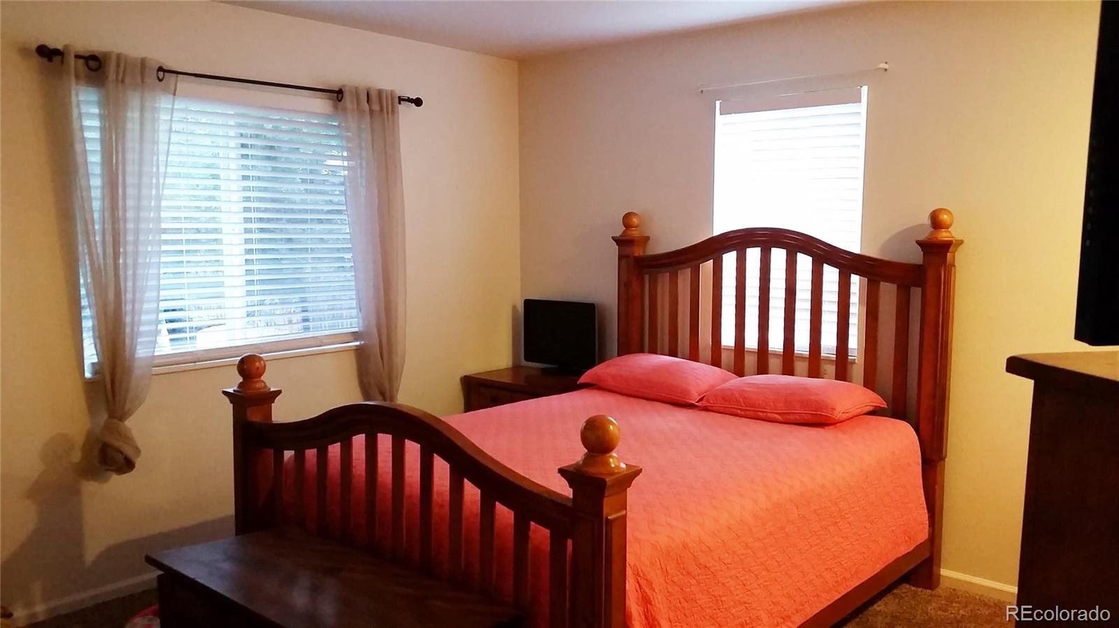 1910 South Decatur Street, Unit C Denver, CO 80219 - Photo 6 of 15 a bedroom with a bed and a window