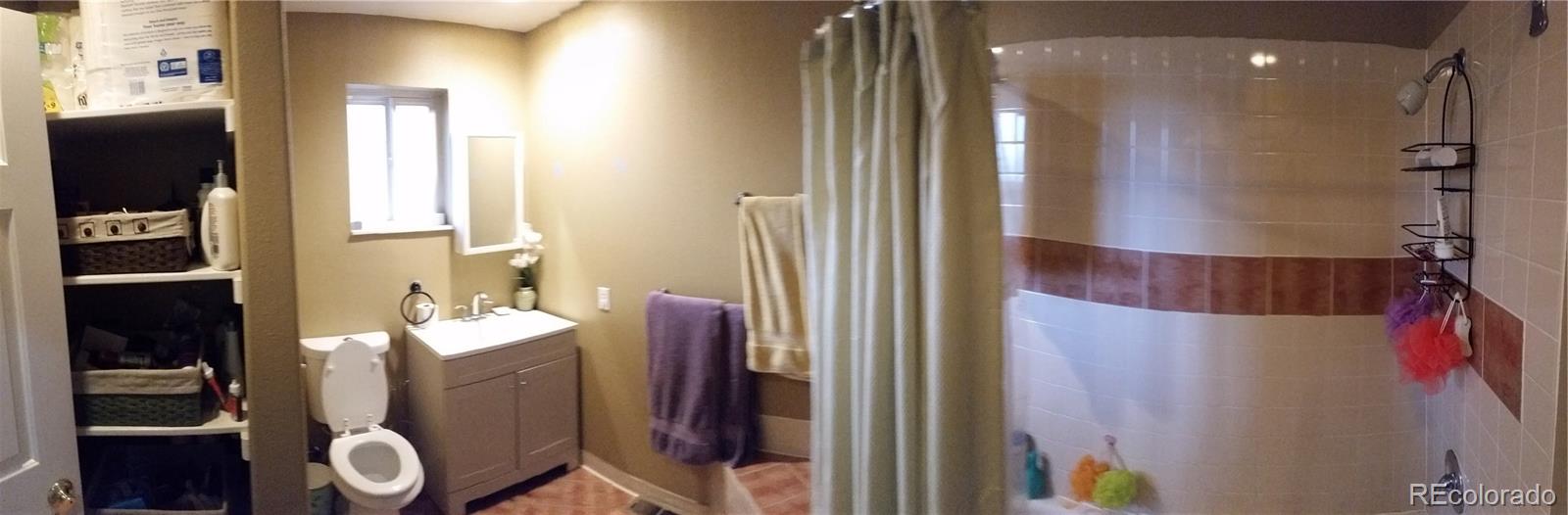1910 South Decatur Street, Unit C Denver, CO 80219 - Photo 9 of 15 a bathroom with a sink and a mirror
