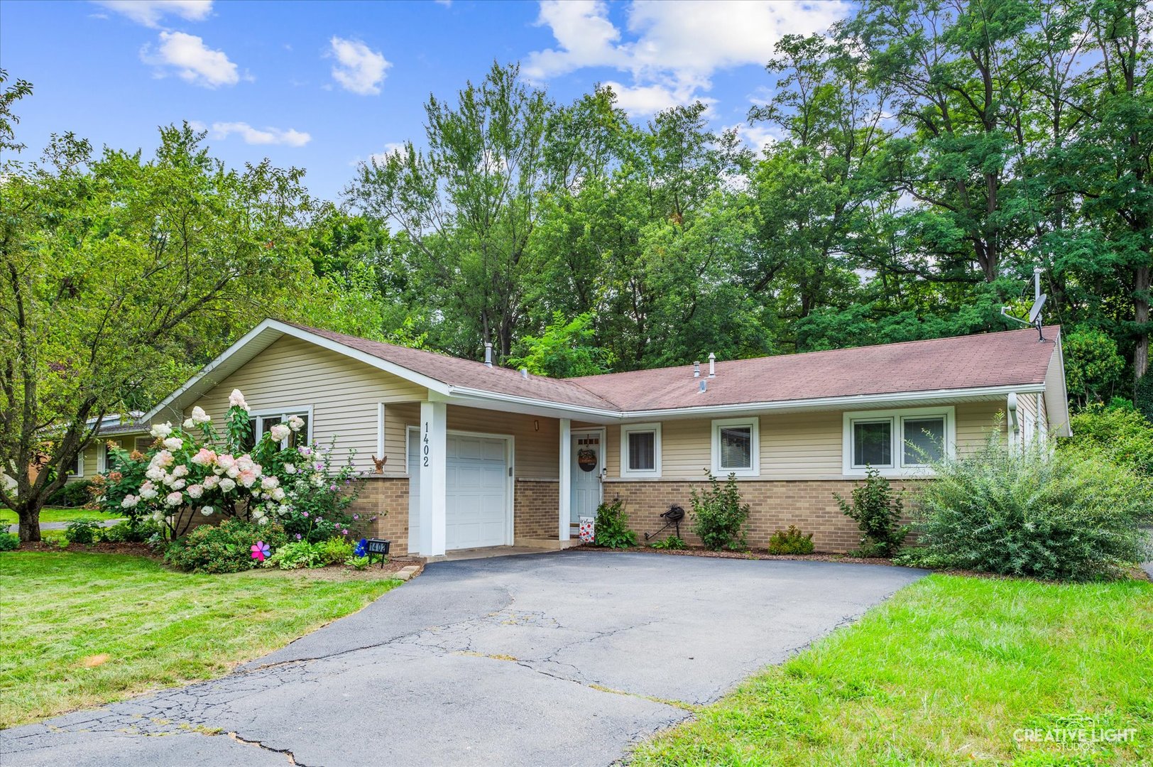 1402 Dunstan Road Geneva, IL 60134 - Photo 1 of 1 a front view of a house with a yard and trees