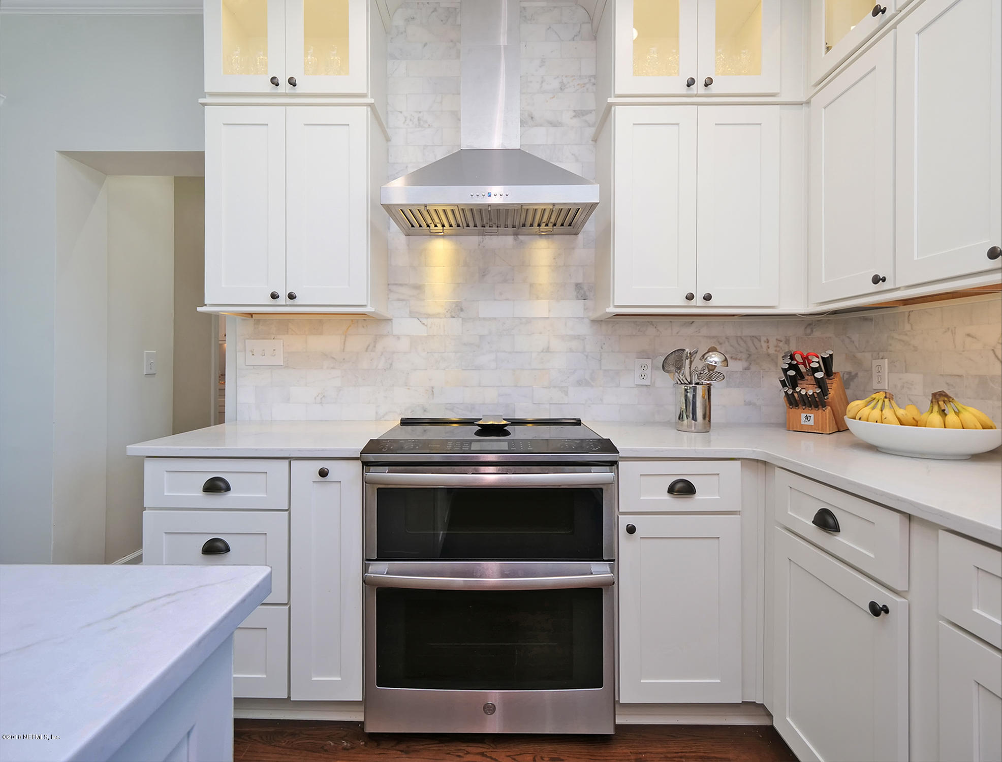 974 Waterman Road South Jacksonville, FL 32207 - Photo 9 of 43 a kitchen with granite countertop white cabinets and white appliances