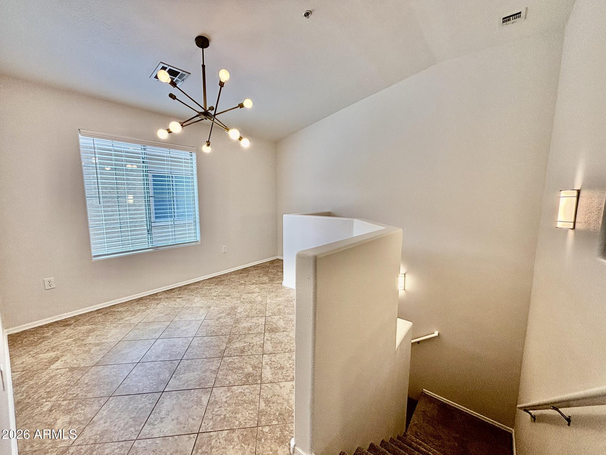 1350 South Greenfield Road, Unit 2041 Mesa, AZ 85206 - Photo 13 of 33 a view of an empty room with a chandelier fan