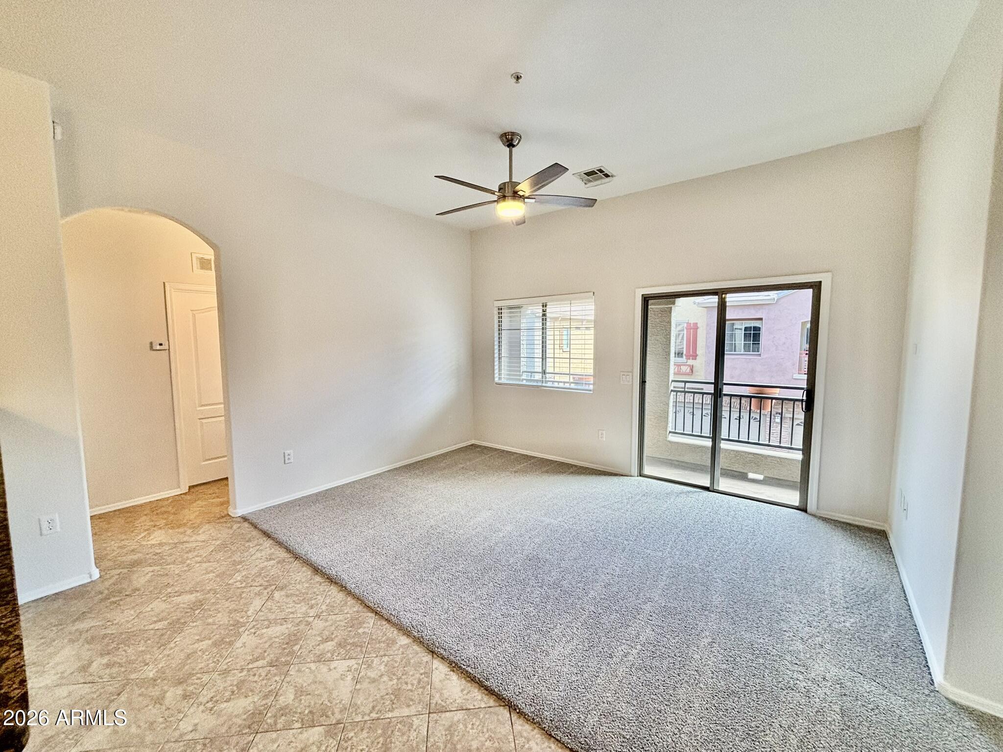 1350 South Greenfield Road, Unit 2041 Mesa, AZ 85206 - Photo 15 of 33 an empty room with windows and ceiling fan