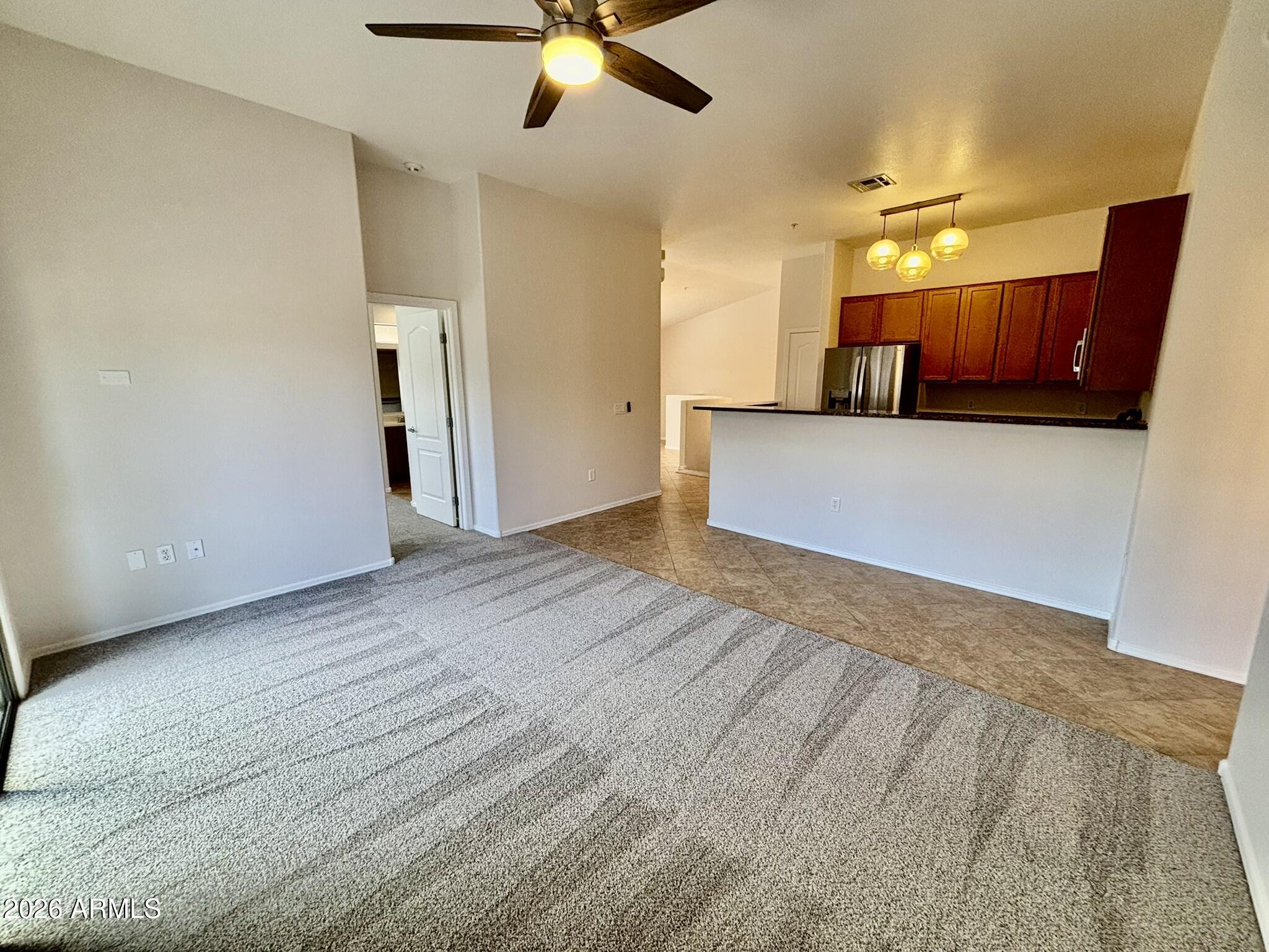 1350 South Greenfield Road, Unit 2041 Mesa, AZ 85206 - Photo 17 of 33 a view of a kitchen with a sink and a ceiling fan