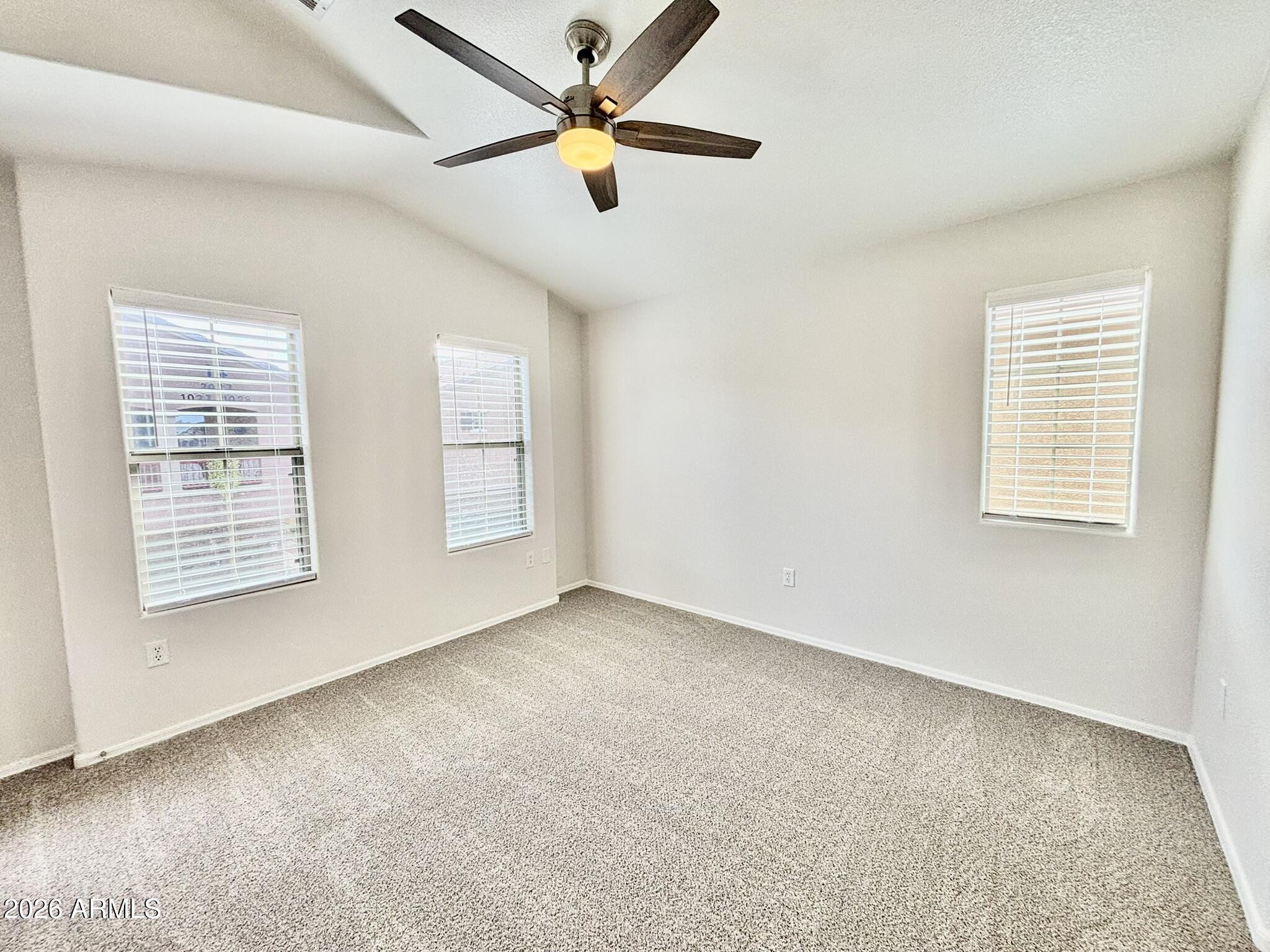 1350 South Greenfield Road, Unit 2041 Mesa, AZ 85206 - Photo 18 of 33 an empty room with windows and fan