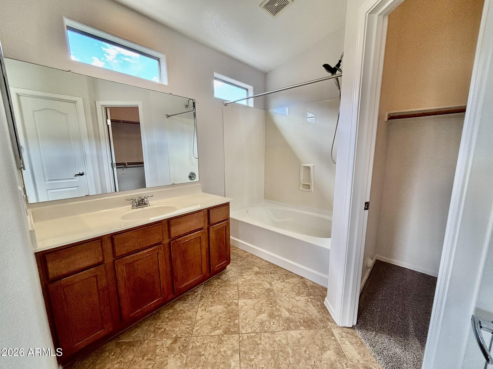1350 South Greenfield Road, Unit 2041 Mesa, AZ 85206 - Photo 20 of 33 a bathroom with a tub sink and mirror