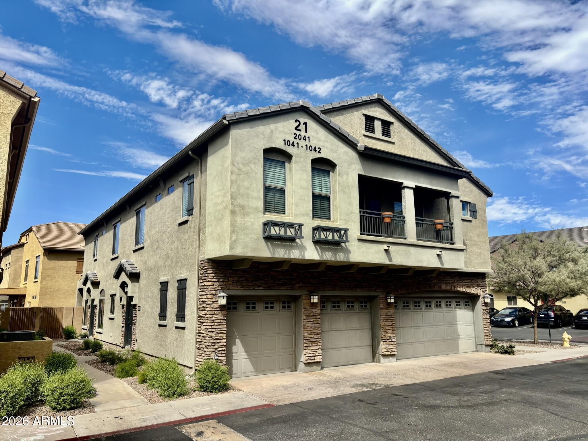 1350 South Greenfield Road, Unit 2041 Mesa, AZ 85206 - Photo 2 of 33 a front view of a house with a garden